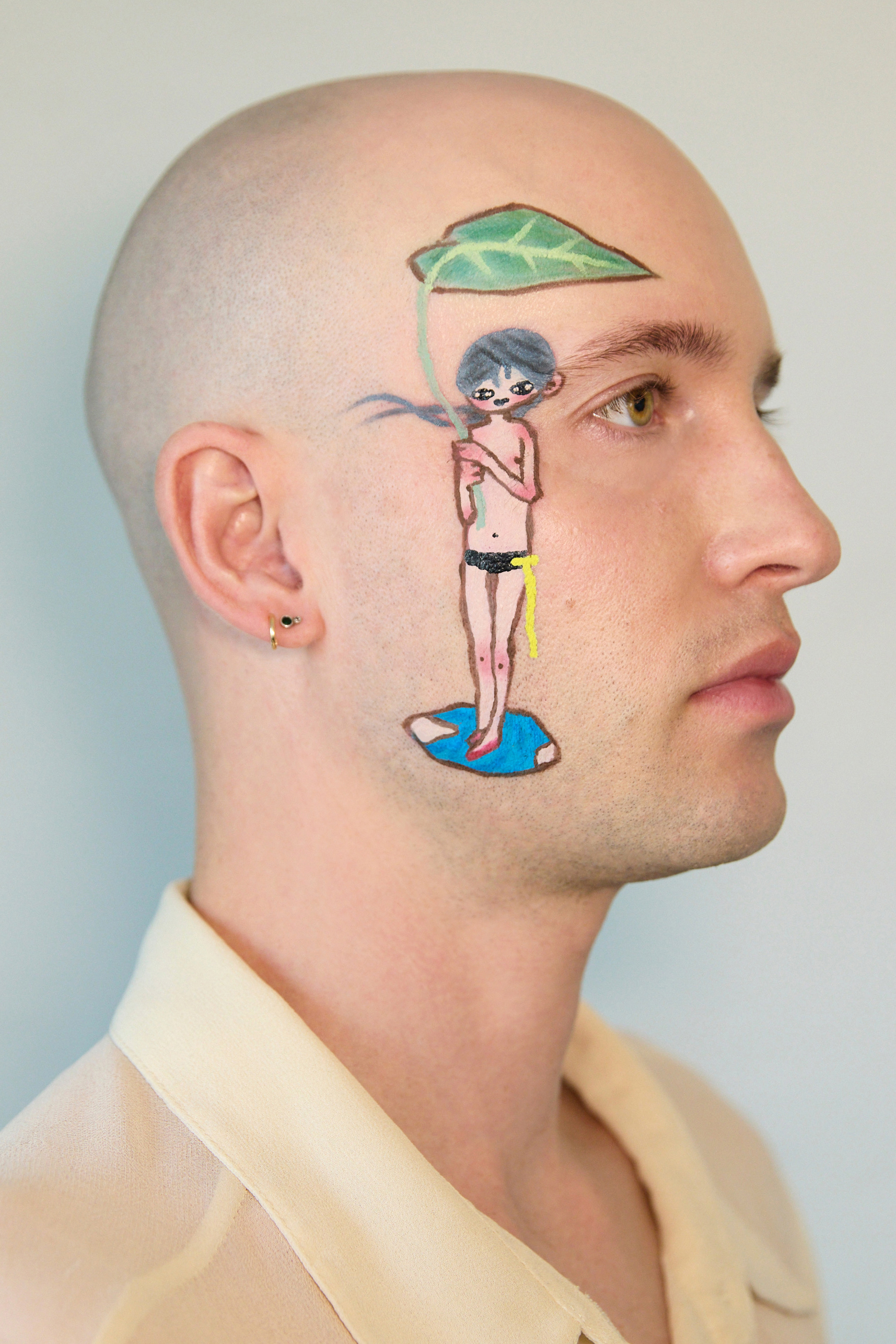 Close up profile portrait of Jesse with a character by aya takano holding a leaf and standing in a puddle painted on his face